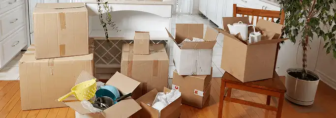 Packed moving boxes and household items in a kitchen before move-out or move-in cleaning, Manchester, NH.